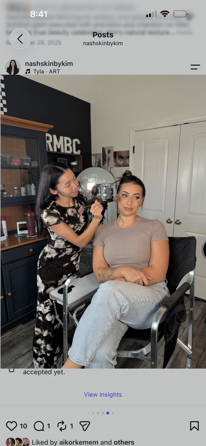 Kim Matthews applying makeup to a client